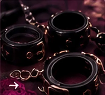 Illustrative black wrist cuffs and bondage accessories